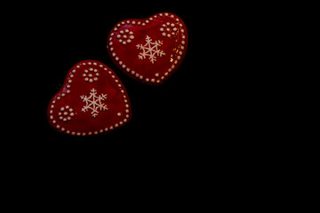 two red hearts made of clay on a black background. Valentine cards are on a black background, the Concept of greetings with Valentine's Day. Secret greeting card for lovers. horizontal photo