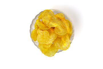 chips in bowl isolated on white background. Potato chips in a transparent glass bowl top view
