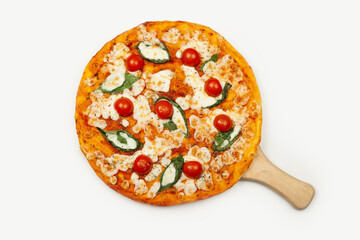 Delicious pizza margarita served on a wooden plate, ingredients sauce, basil, mozzarella and cherry tomatoes isolated on white View from above Promotional flyer and poster for restaurants or pizzerias