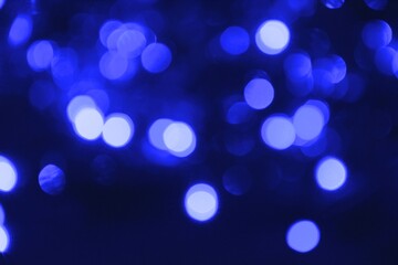 Fototapeta na wymiar Lights blurred bokeh abstract on dark background, rozmyte światełka na ciemnym tle lampki świąteczne