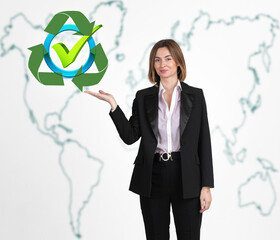 Young and attractive woman in suit holding abstract recycle icon with world map behind