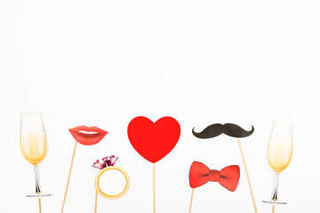 Valentine's day, love, wedding concept. Red heart, champagne glass, mustaches and lips paper prop...