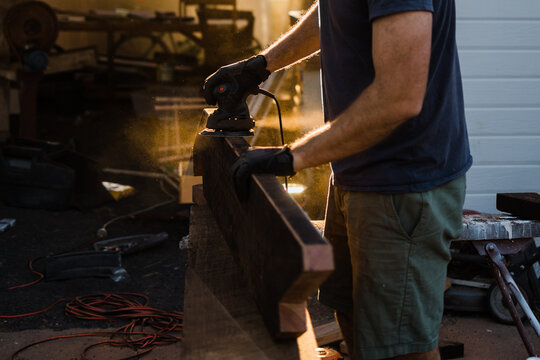 A man sanding stringers