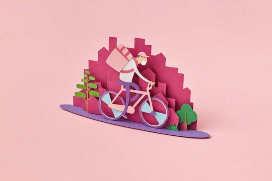Handmade from paper courier bicyclist.