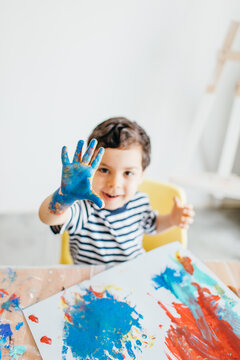 A kid and this father painting at home