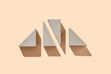 Wooden three-dimensional triangles with shadows.