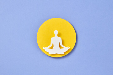 Paper man in the process of yoga.