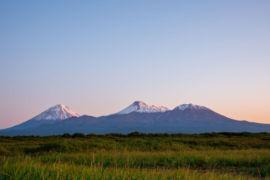 Snowy covered amazing volcanoes peaks in Kamchatka Peninsula, Russia.