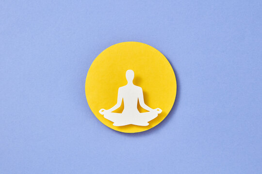 Paper man in the process of yoga.