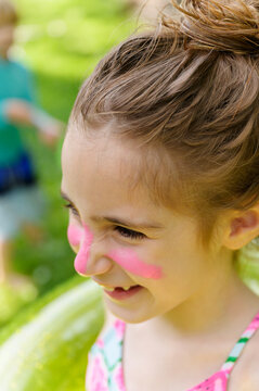 Laughing Girl with Pink Zinc Sunscreen on her Face