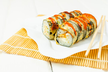 Funny edible Christmas tree made from sushi, creative idea for japanese restaurant on white background. New Year food background top view