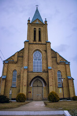 Large brick church on a cloudy day. Yellow brick church