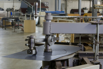   A machine tool cuts round shapes from metal. Factory of metal products.