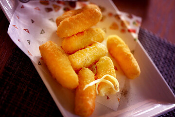Photo of retro delicious cheese sticks in a cafe