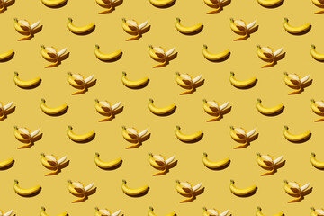 Trendy pattern made with fresh fruits on bright light yellow background. Minimal style with colorful paper backdrop. Colorful photo. Flat lay. Minimal creative concept. Food background. Bananas