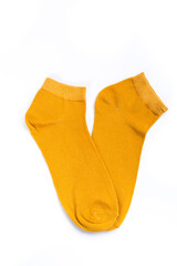 a pair of yellow short socks on a white background, top view
