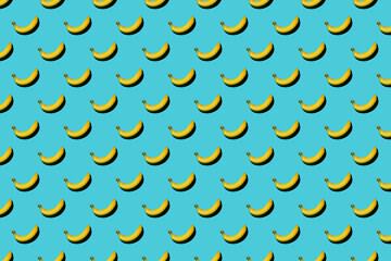 Trendy pattern made with fresh fruits on bright light blue background. Minimal style with colorful paper backdrop. Colorful photo. Flat lay. Minimal creative concept. Food background. Bananas