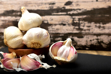 Organic white garlic on a black slate plate