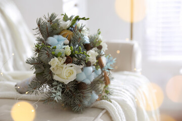 Beautiful wedding winter bouquet on sofa indoors, space for text. Bokeh effect