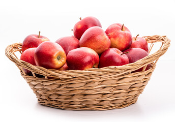 Red apples in a wicker basket. Isolate on white background