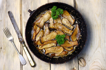 Selective focus. Fried eringi mushrooms in a pan. Vegan lunch.