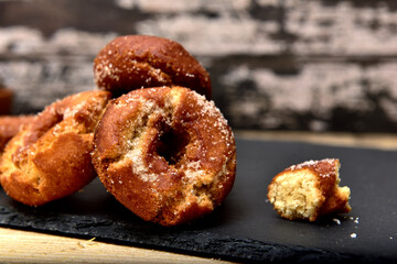 Sweet Spanish doughnuts on a black slate plate
