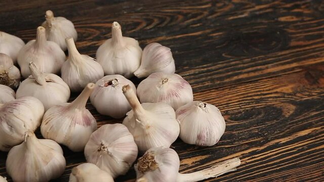 Heap of fresh garlic on wooden background