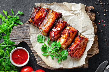 ribs grilled BBQ spices tomato sauce piece of meat second course snack ready to eat on the table meal snack top view copy space for text food background rustic