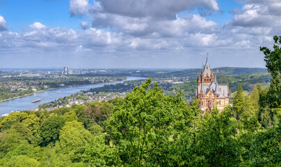 Panoramic view over the castle Drachenburg on the hill Drachenfels in Siebengebirge, the town Königswinter and Bonn, the river Rhine valley and the Cologne Lowland, NRW, Germany 