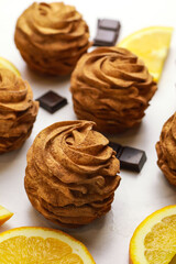 Tasty zephyr wth chocolate and orange on light background