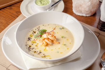 White vegetable soup with tiger-prawns