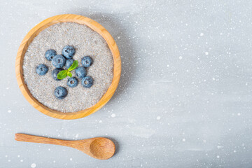 chia pudding with blueberries in a wooden plate