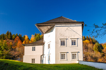 Historic building with sundial in The Spania Dolina village, Slovakia, Europe. - obrazy, fototapety, plakaty