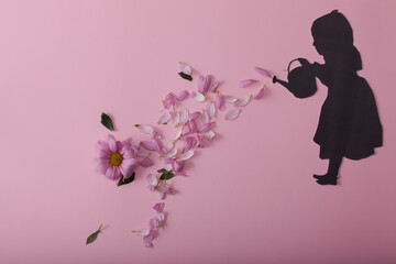 silhouette of a girl with flowers on a pink background
