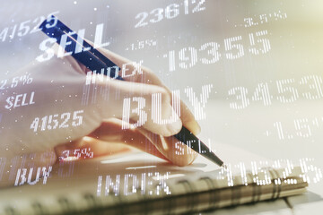 Double exposure of abstract creative financial chart with hand writing in notebook on background, research and strategy concept