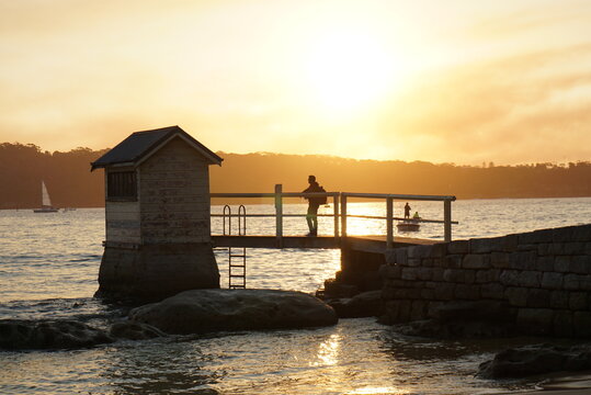 Sunset behind a small hut in Ocean with tiny bridge connected to it. Picture taken in Watsons Bay, Sydney, Australia.