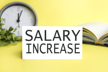 salary increase. word. text. on white paper on yellow background