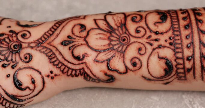 Female arm with beautiful henna tattoo, closeup