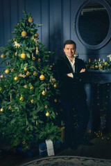 Elegant man near the Christmas tree