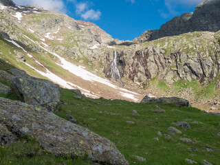 view of wild river, waterfall from melting ice at hiking trail, Stubai Hohenweg Tyrol, Austrian Alps