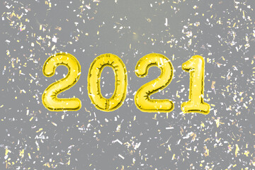 2021 New Year yellow numbers on gray background with confetti. Christmas party holiday decor. Color of the year