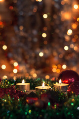Fototapeta na wymiar Candles and Christmas decorations on dark background with lights