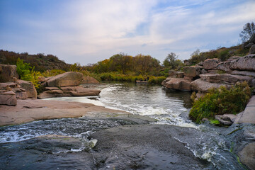 Small fast waterfall Kamenka in the evening light in Ukraine