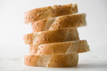 Sliced fresh bread baguette in vertical with white background