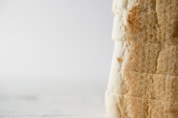 Sliced fresh bread baguette in vertical with white background