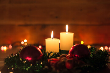 Candles and Christmas decorations on dark background with lights