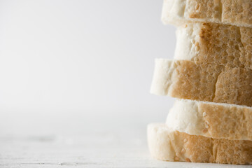 Sliced fresh bread baguette in vertical with white background