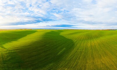 Flying over an green empty field