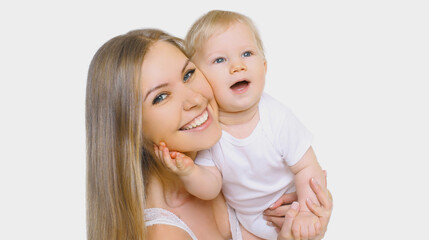 Portrait of cheerful smiling mother and baby playing together over a white background