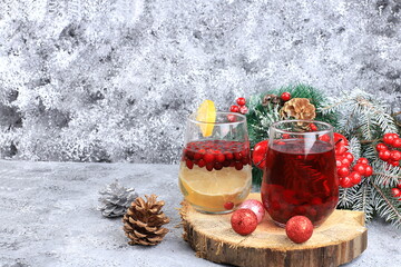 Strong alcoholic or non-alcoholic cranberry and cinnamon spiced cocktail, warming winter drink in the cold season, christmas festive grog, winter composition, selective focus